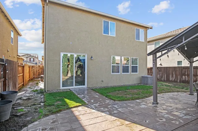 a view of a house with a yard and stairs