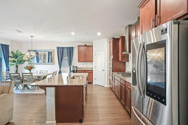 a large kitchen with kitchen island granite countertop a large counter top appliances and cabinets