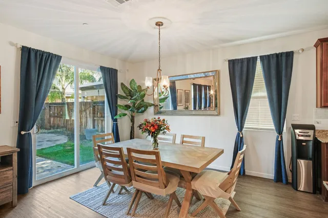 a dining room with furniture window and wooden floor