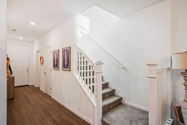 a view of entryway and hall with wooden floor