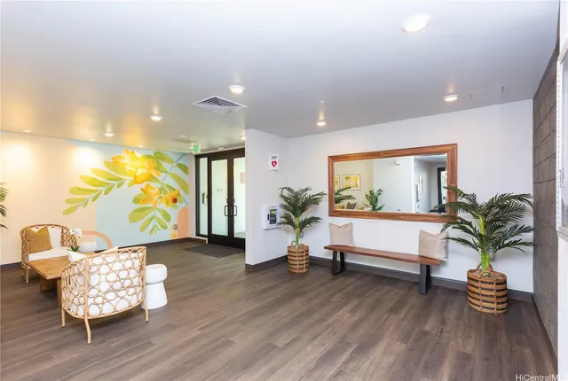 a hallway with a wooden floor and furniture