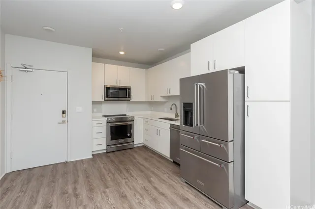 a kitchen with a refrigerator stove and microwave