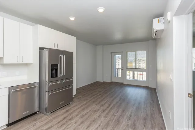 a kitchen with stainless steel appliances a refrigerator and a stove top oven