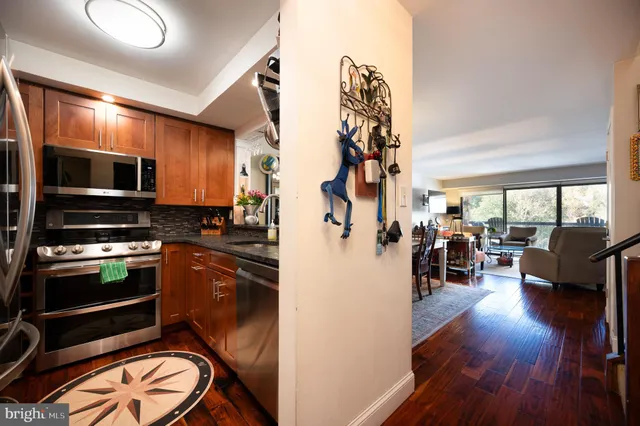 a view of kitchen and living room with wooden floor
