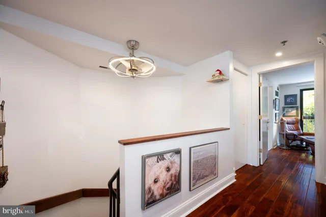 a view of entryway and hall with wooden floor