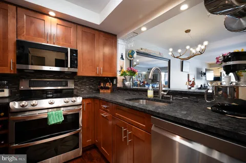 a kitchen with stainless steel appliances a stove microwave and cabinets