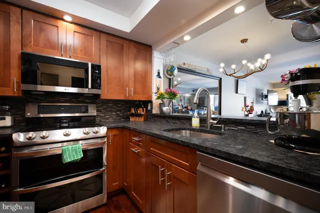 a kitchen with stainless steel appliances a stove microwave and cabinets