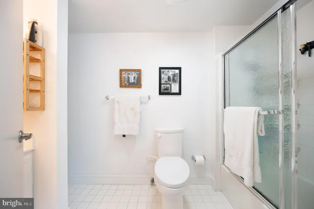 a bathroom with a toilet sink and shower