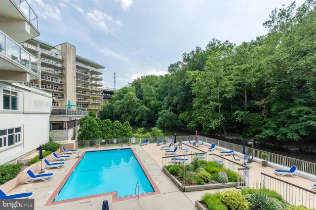 a view of swimming pool with outdoor seating and lake view