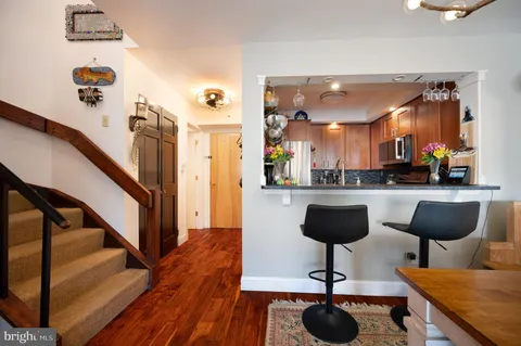 a view of living room kitchen with furniture and wooden floor