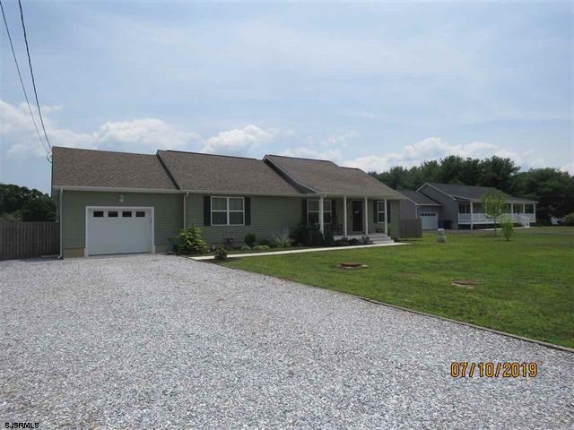 57 Perry Road Woodbine, NJ 08270 - Photo 1 of 1 a front view of a house with a yard and garage