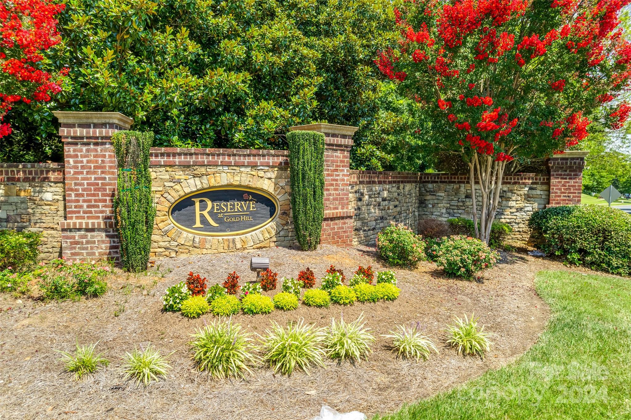 674 Quicksilver Trail Fort Mill, SC 29708 - Photo 36 of 45 a front view of a house with a yard and a garden