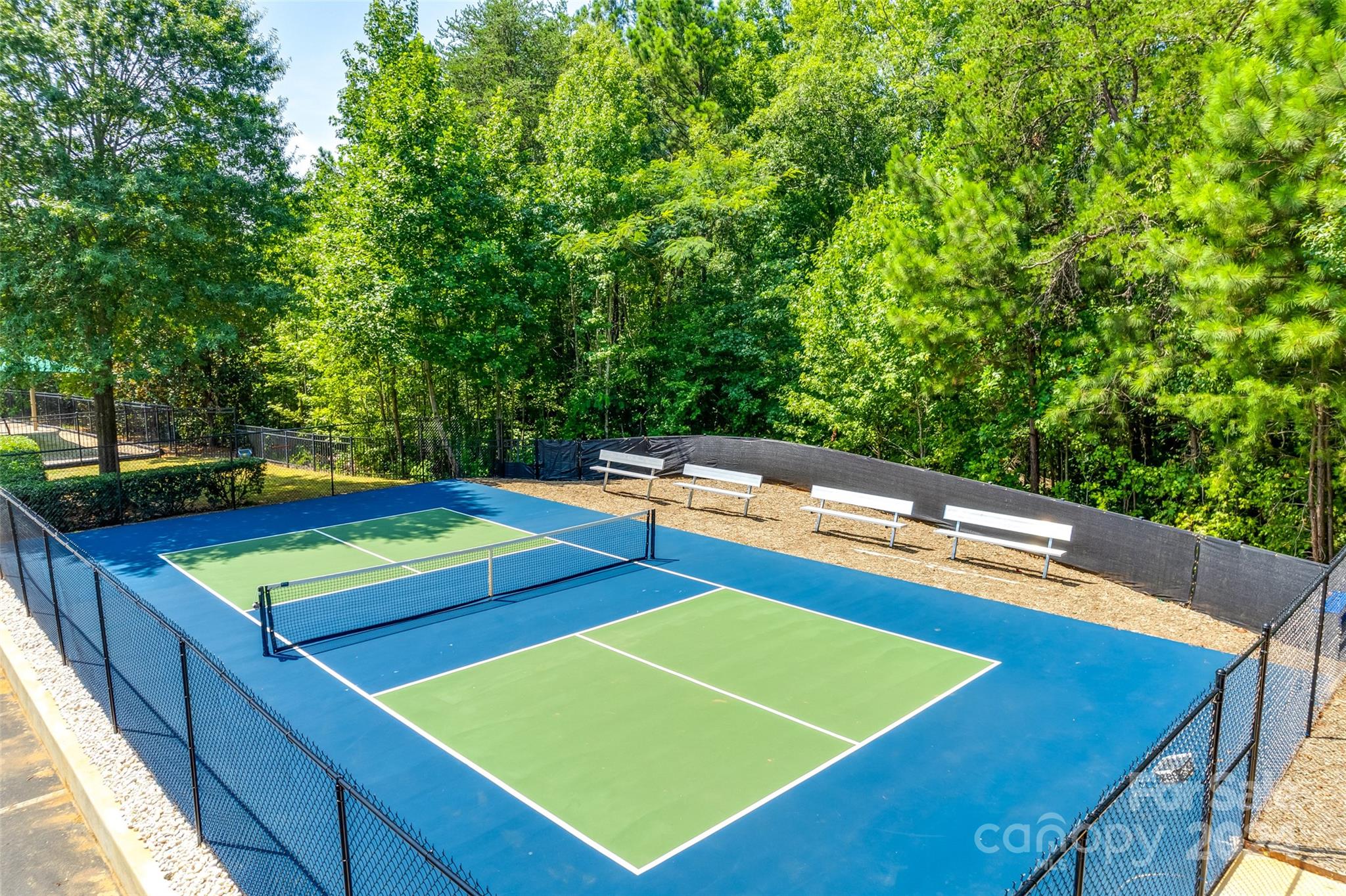 674 Quicksilver Trail Fort Mill, SC 29708 - Photo 41 of 45 a view of a tennis ground with large trees