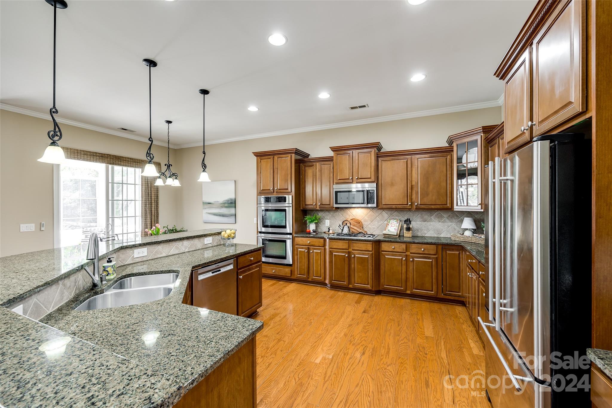 674 Quicksilver Trail Fort Mill, SC 29708 - Photo 8 of 45 a large kitchen with kitchen island granite countertop a large counter top stainless steel appliances and cabinets