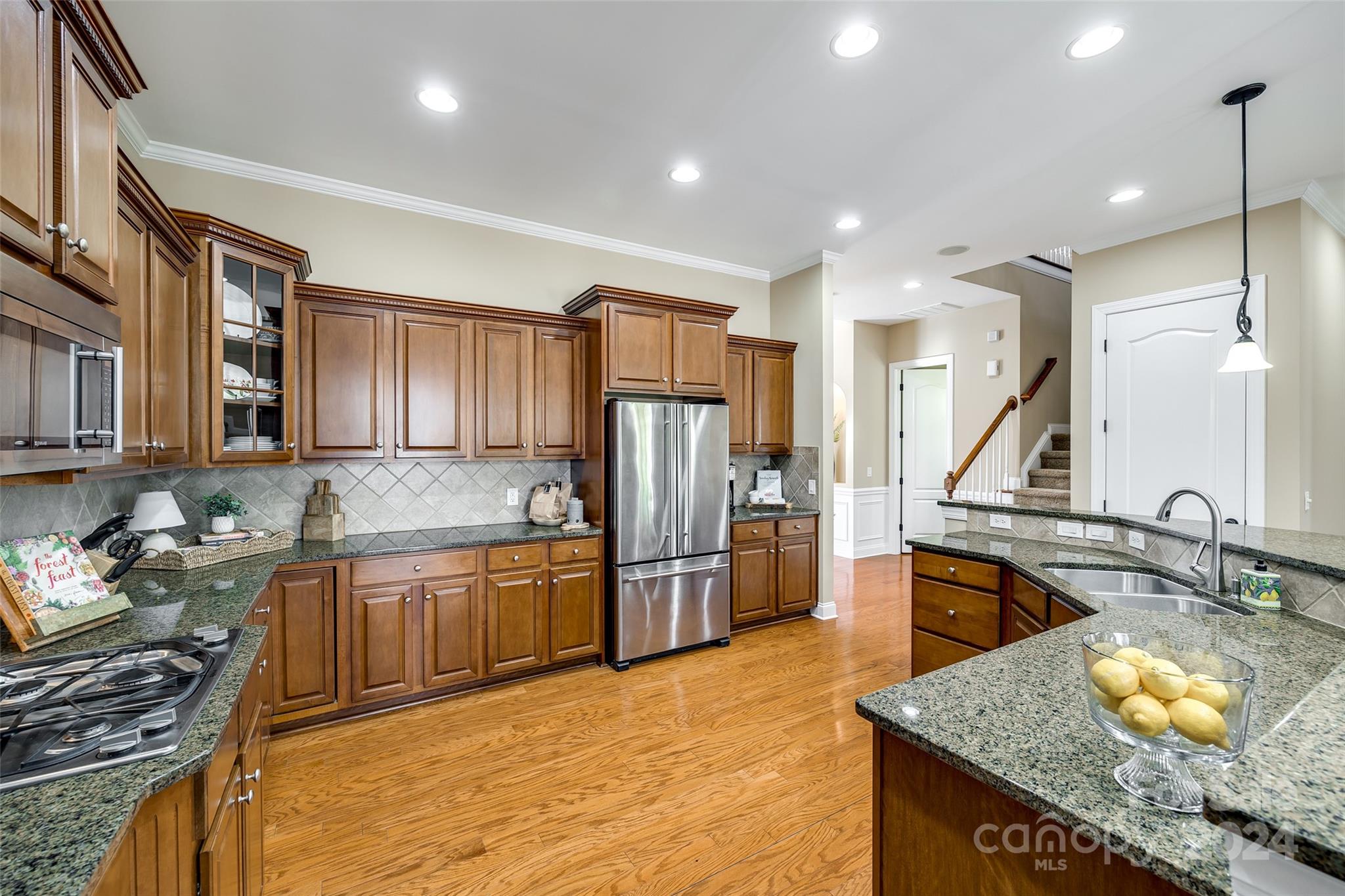 674 Quicksilver Trail Fort Mill, SC 29708 - Photo 9 of 45 a kitchen with stainless steel appliances granite countertop a sink stove and refrigerator