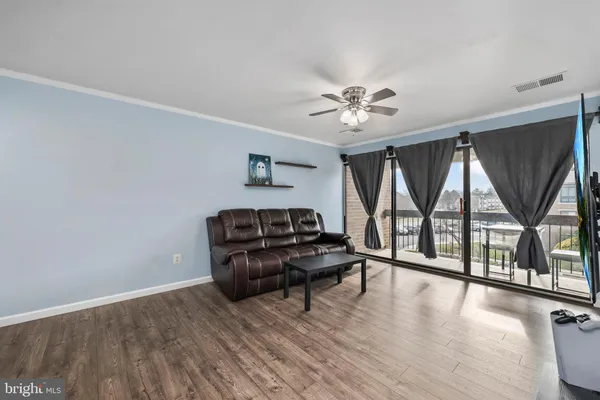 a living room with furniture and a floor to ceiling window