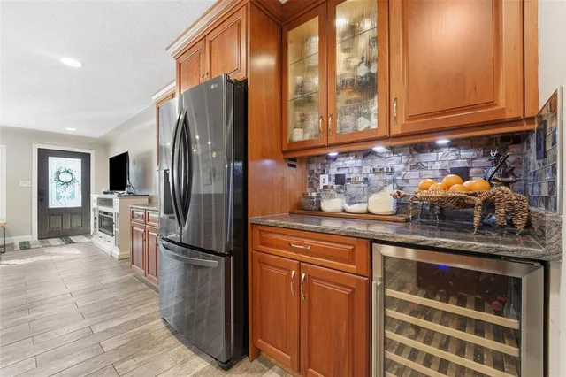 a kitchen with stainless steel appliances granite countertop a stove a sink dishwasher and a refrigerator