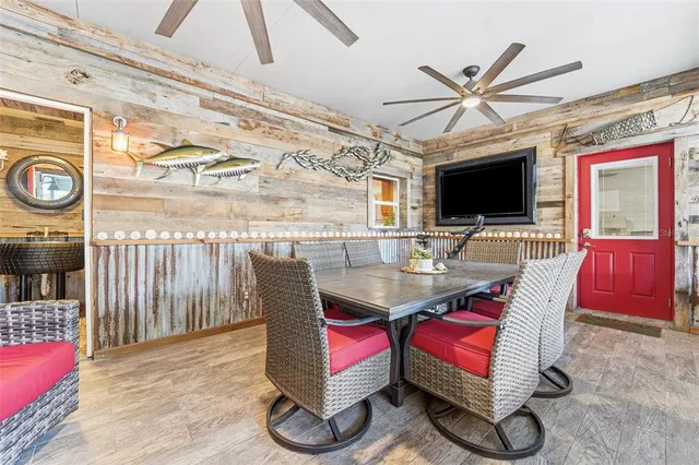 a living room with furniture a flat screen tv and a large window