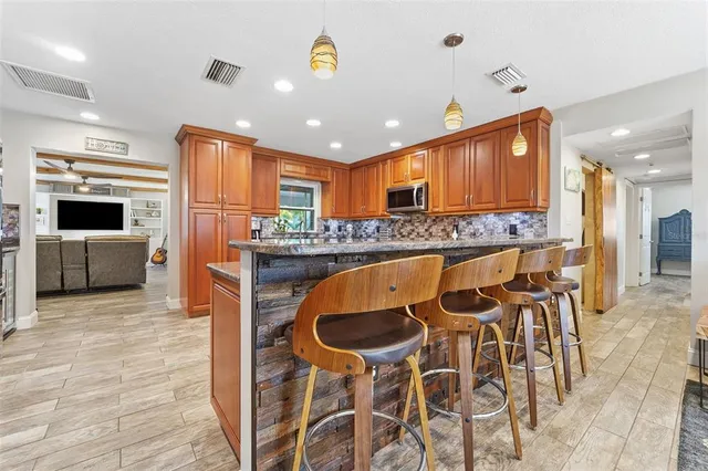 a kitchen with stainless steel appliances granite countertop a stove sink and cabinets