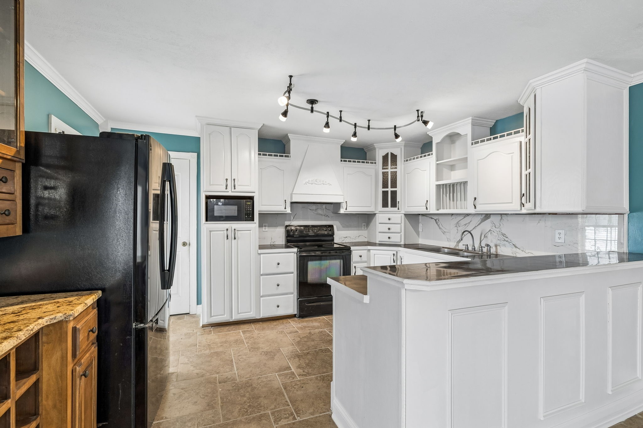 6701 McCormick Ridge Road Whitleyville, TN 38588 - Photo 18 of 63 a kitchen with stainless steel appliances granite countertop a refrigerator a stove and a sink