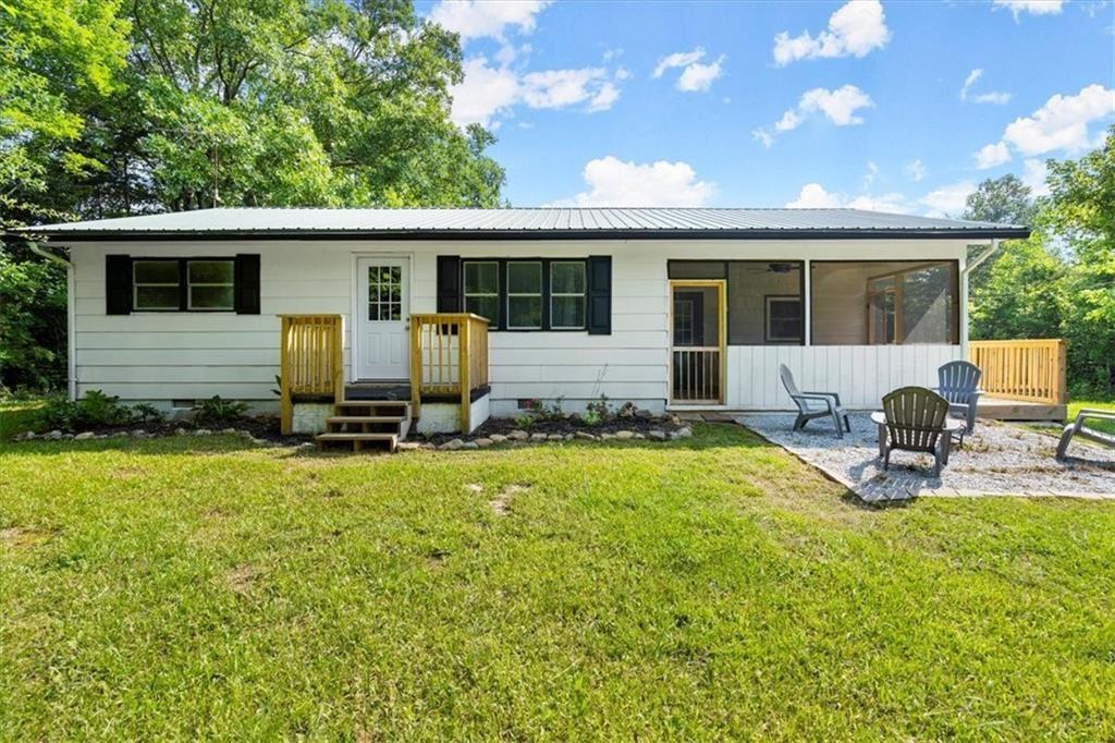 1815 Damascus Road Blue Ridge, GA 30513 - Photo 1 of 1 a view of a house with backyard sitting area and garden