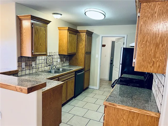 a kitchen with a sink a granite counter top and a granite top
