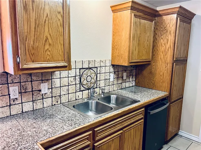 a view of kitchen with granite countertop cabinets a sink and a counter top space