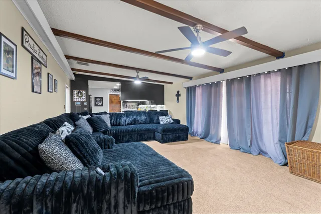 a spacious bedroom with a bed and a mirror