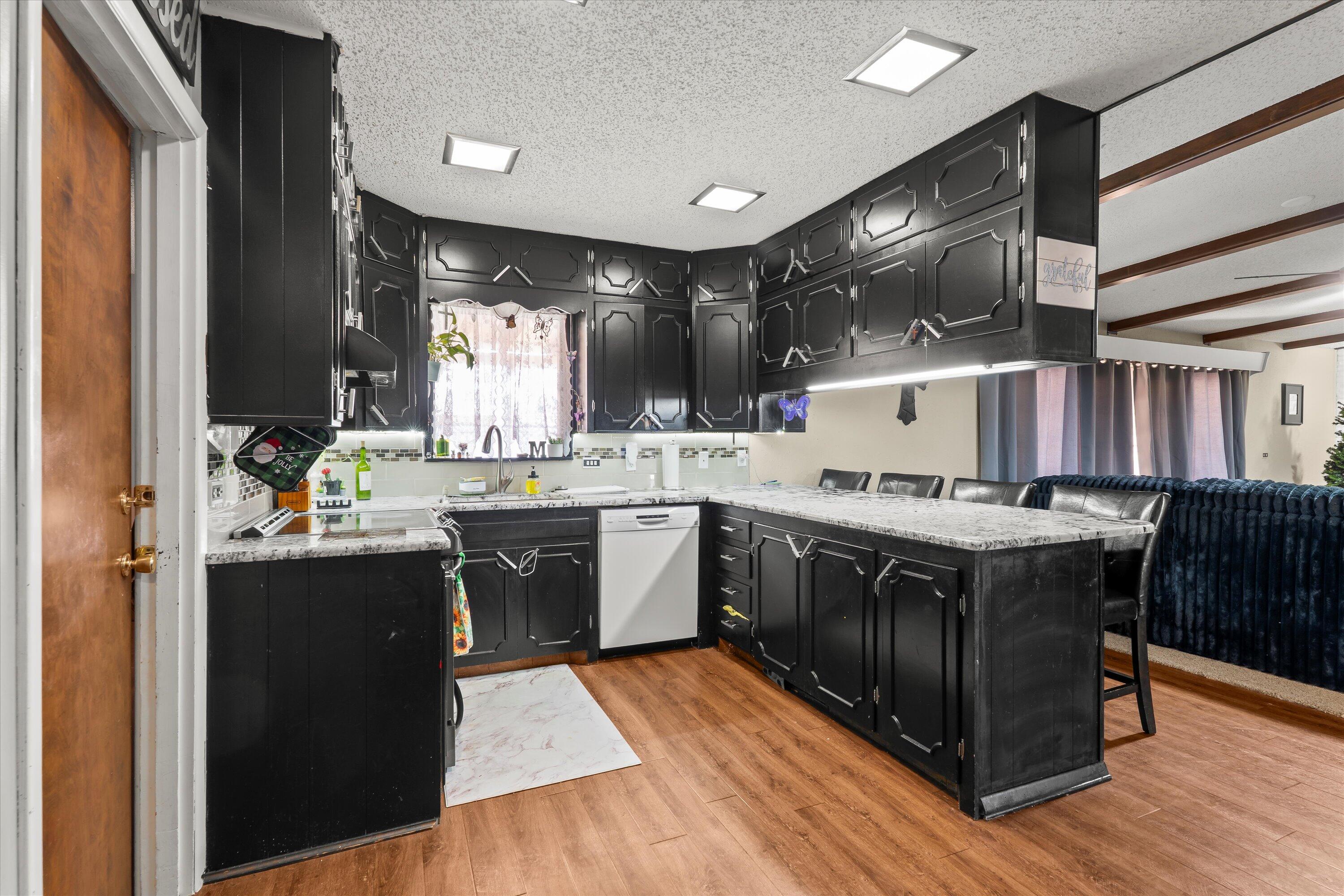 403 Crescent Drive Littlefield, TX 79339 - Photo 13 of 35 a kitchen with a sink cabinets and wooden floor