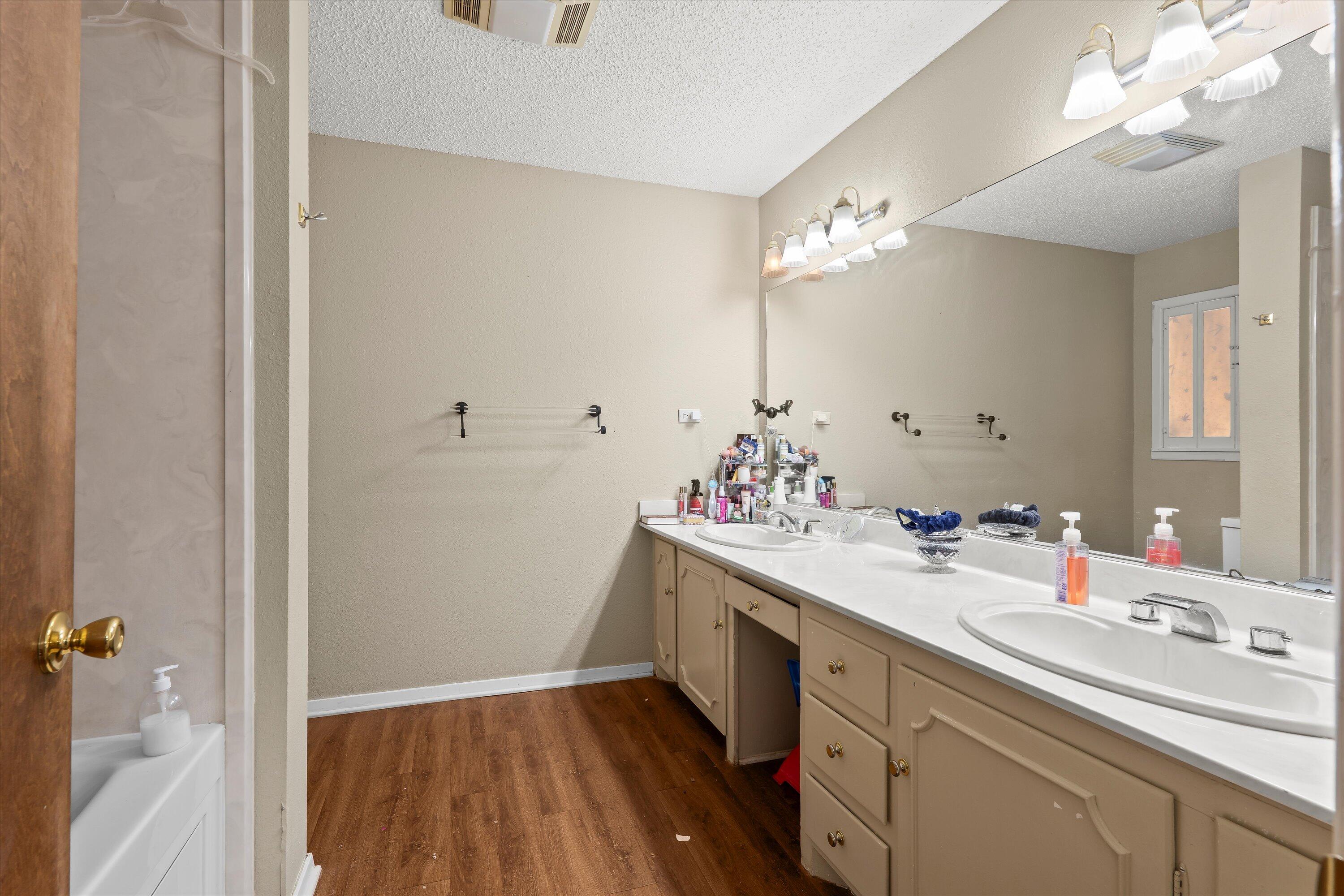 403 Crescent Drive Littlefield, TX 79339 - Photo 17 of 35 a bathroom with a sink vanity granite and a mirror