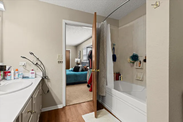 a en suite bathroom with a tub sink and mirror