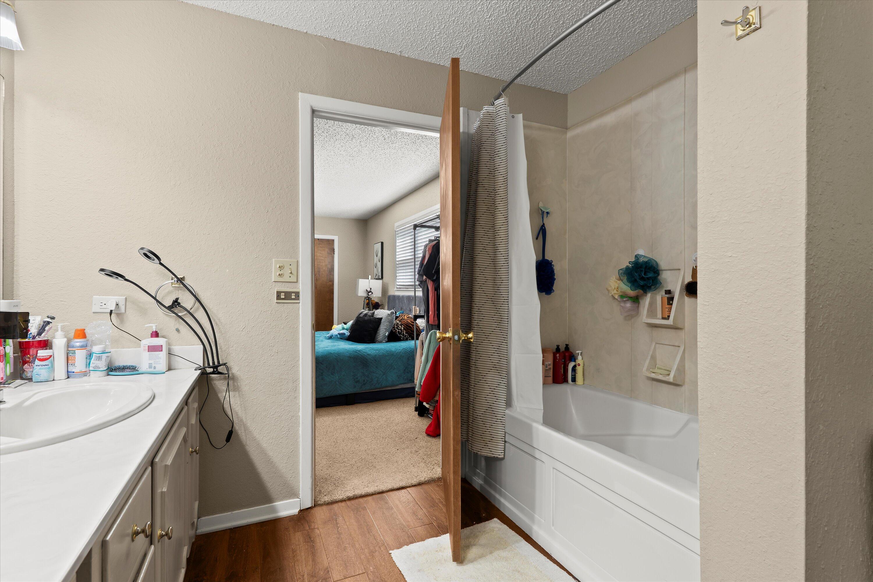 403 Crescent Drive Littlefield, TX 79339 - Photo 18 of 35 a en suite bathroom with a tub sink and mirror