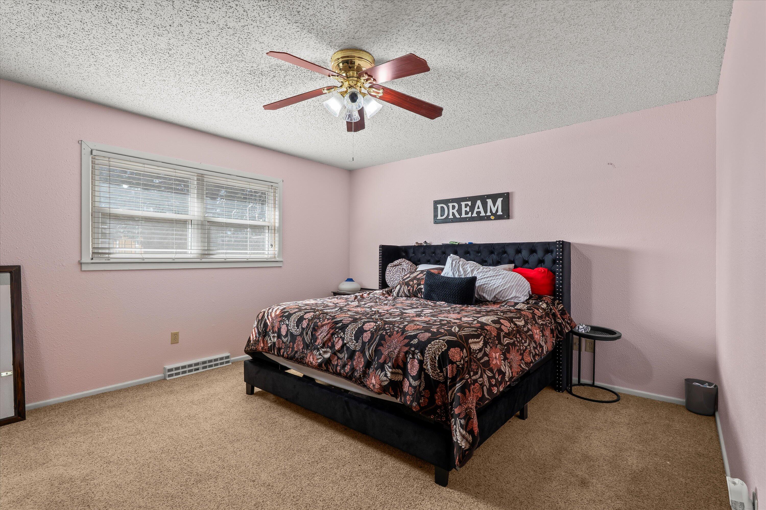 403 Crescent Drive Littlefield, TX 79339 - Photo 25 of 35 a bedroom with a bed and a chandelier