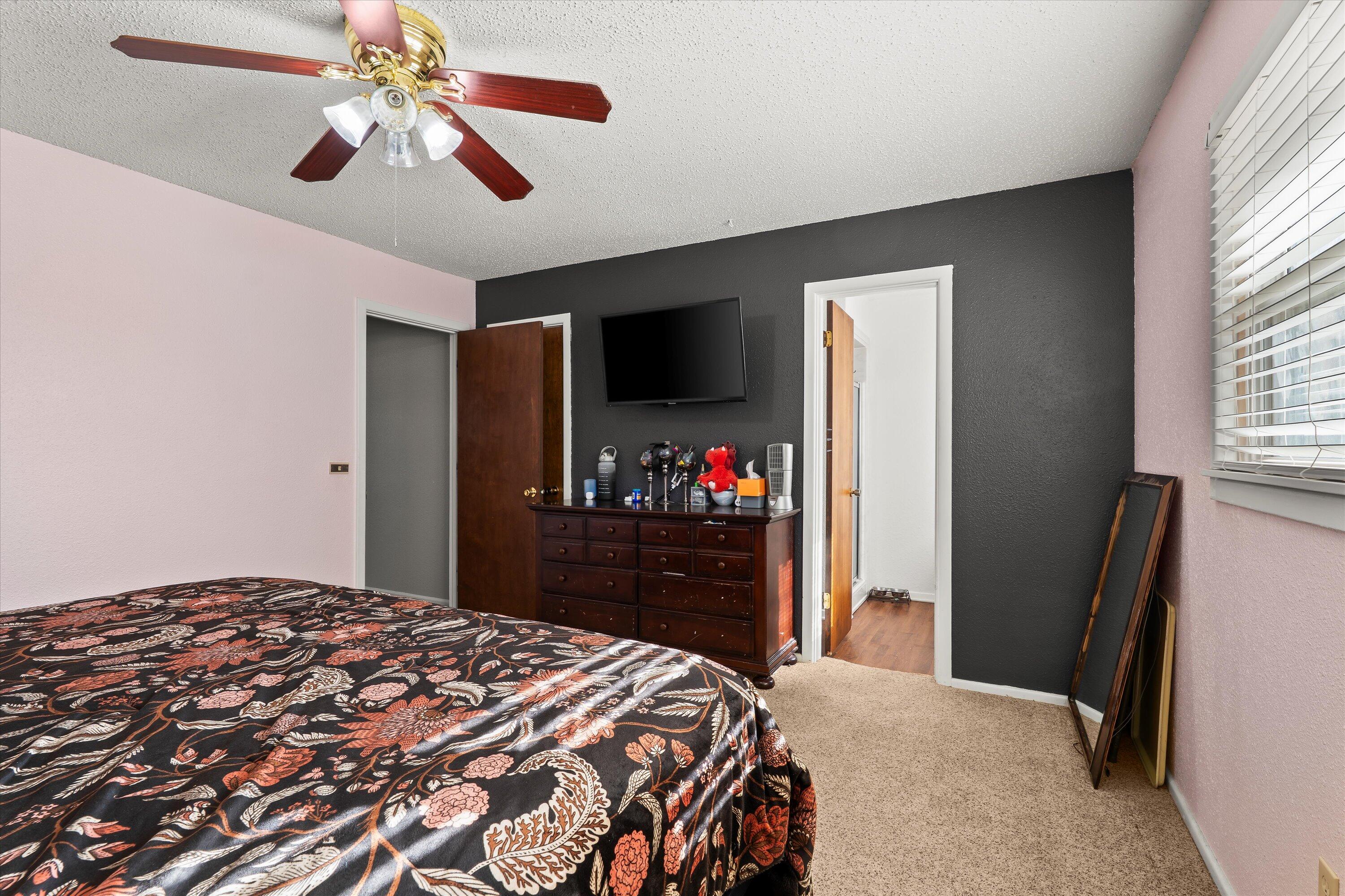 403 Crescent Drive Littlefield, TX 79339 - Photo 26 of 35 a bedroom with a bed and a flat tv screen on dresser