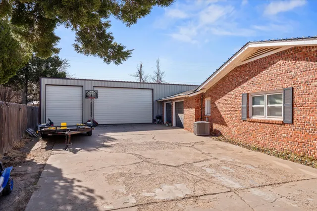 a backyard of a house with barbeque oven and bench