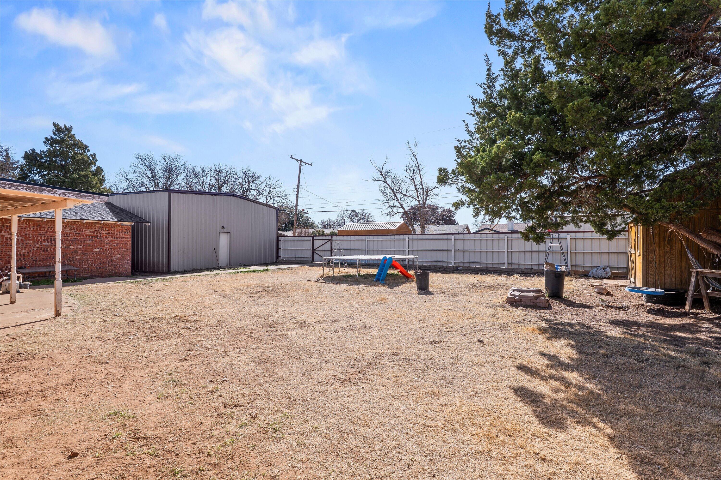 403 Crescent Drive Littlefield, TX 79339 - Photo 33 of 35 a backyard of a house with wooden fence