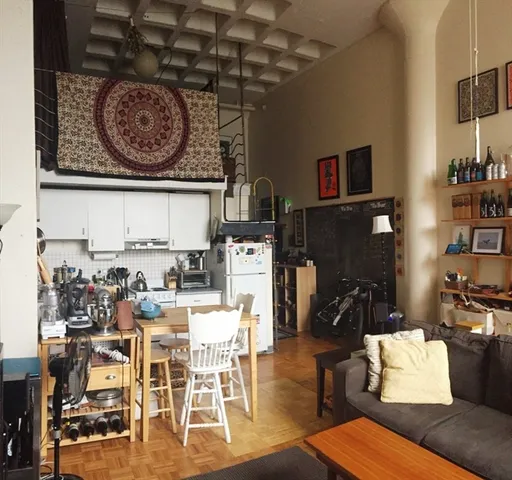 a living room with lots of furniture and a wooden floor