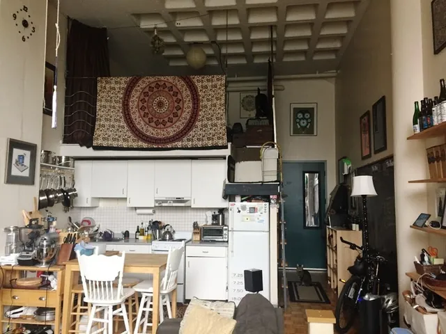 a view of a kitchen with fridge and workspace