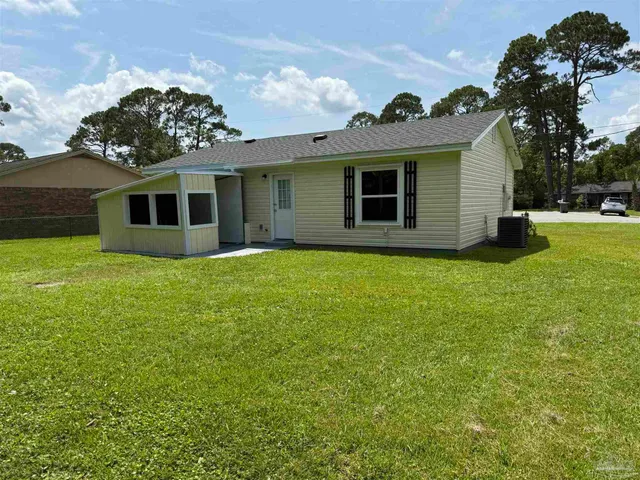 a view of a house with yard and a garden