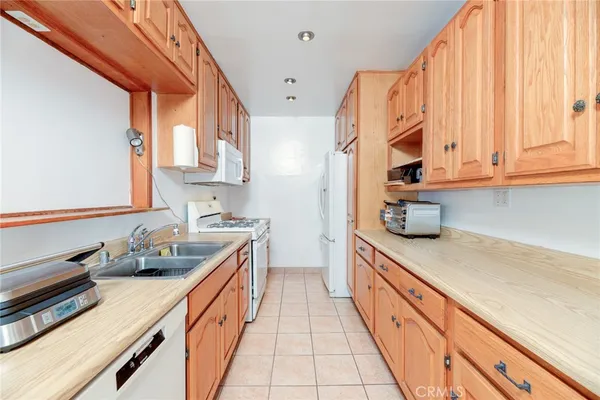 a kitchen with stainless steel appliances a sink a stove and cabinets