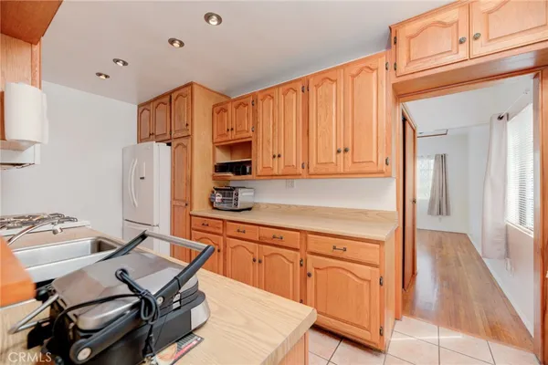 a kitchen with a sink appliances and cabinets