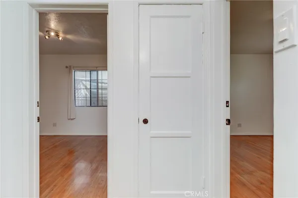 a view of a hallway with wooden floor