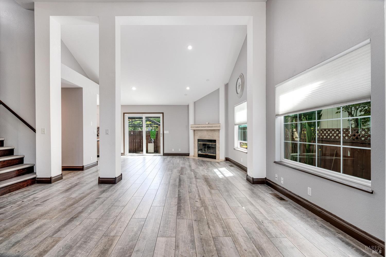 187 Wikiup Meadows Drive Santa Rosa, CA 95403 - Photo 12 of 66 a view of empty room with wooden floor and fireplace