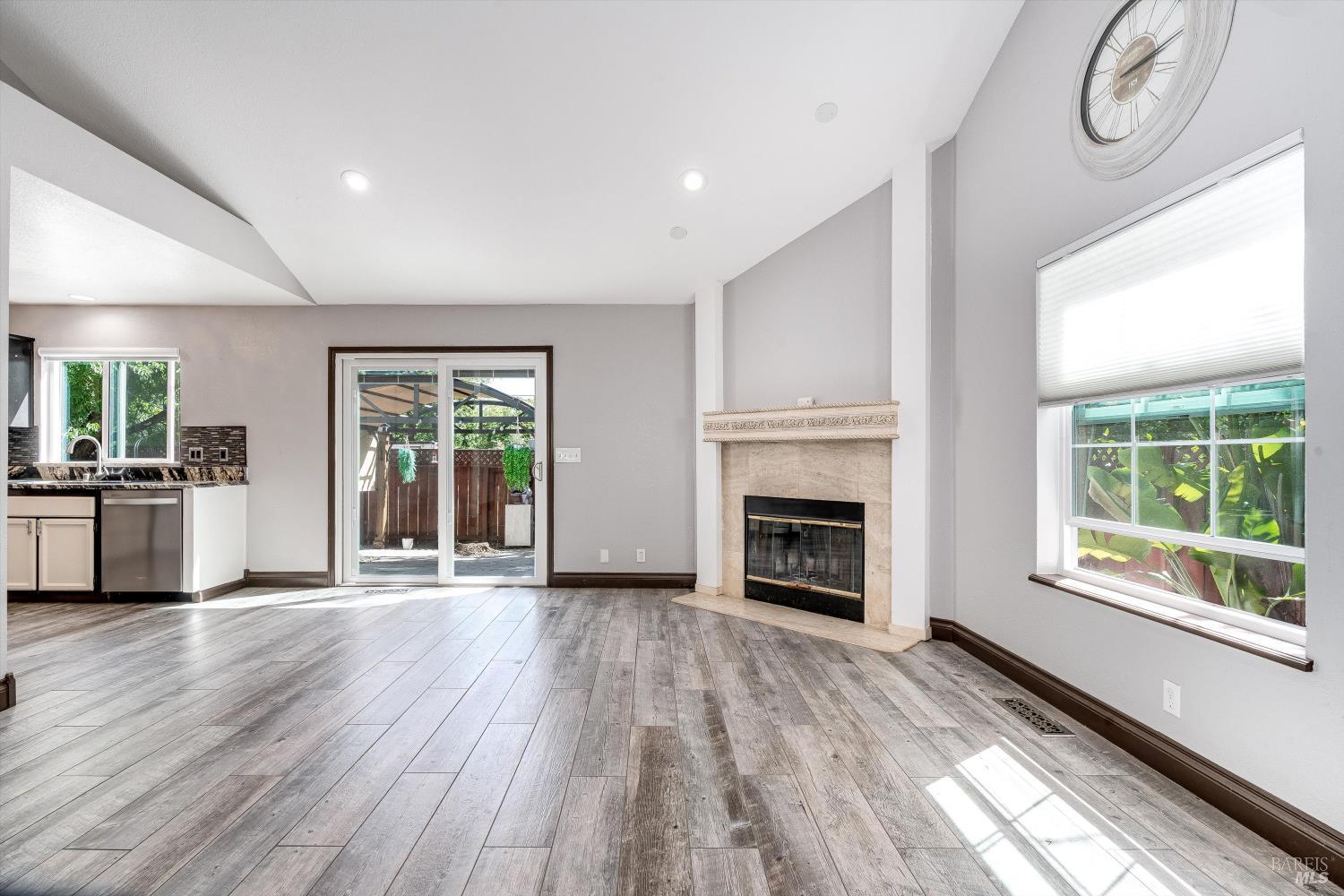 187 Wikiup Meadows Drive Santa Rosa, CA 95403 - Photo 15 of 66 a view of a livingroom with a fireplace wooden floor and windows