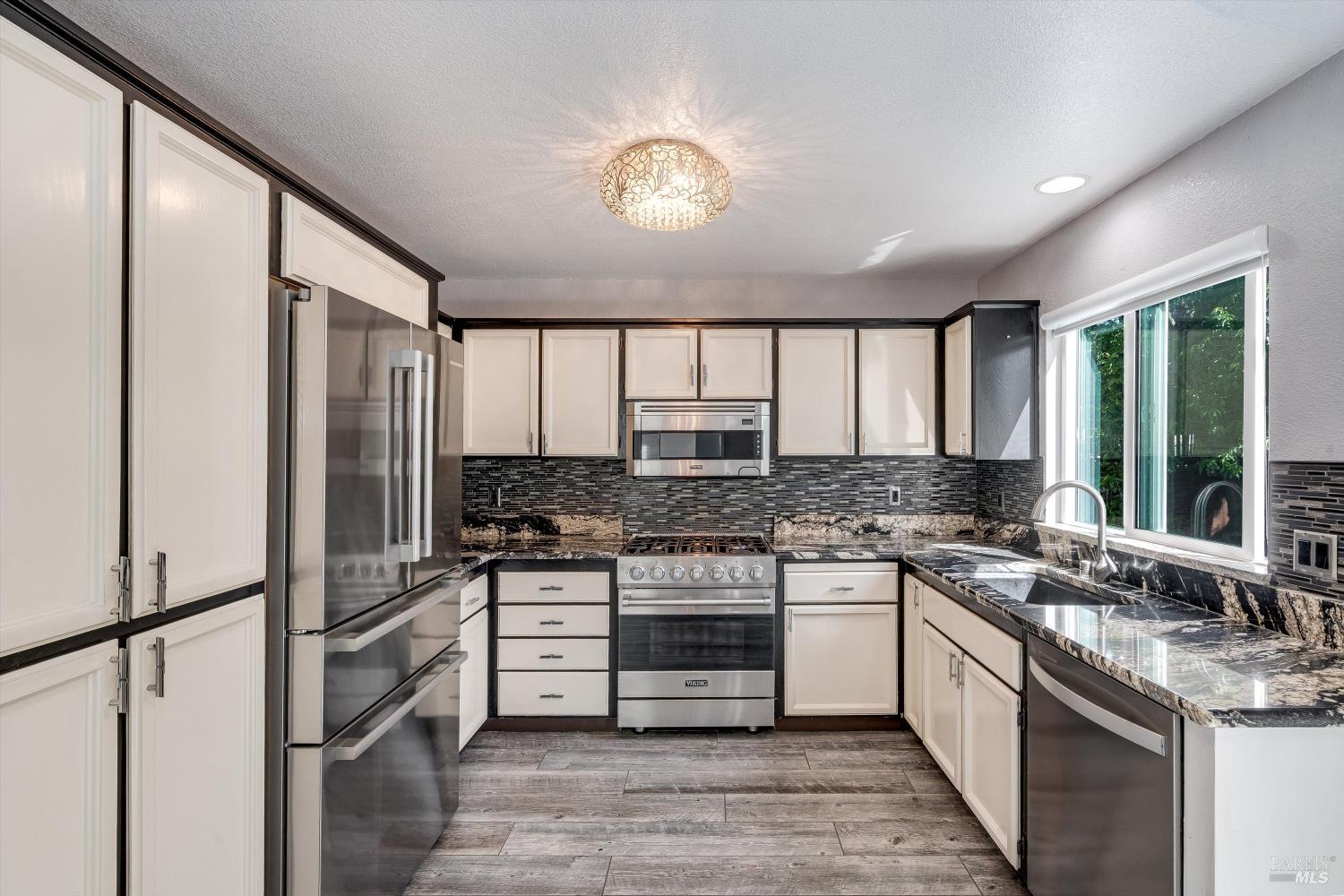 187 Wikiup Meadows Drive Santa Rosa, CA 95403 - Photo 20 of 66 a kitchen with stainless steel appliances granite countertop a stove and a refrigerator