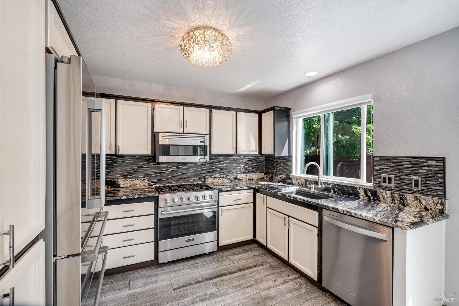 187 Wikiup Meadows Drive Santa Rosa, CA 95403 - Photo 21 of 66 a kitchen with stainless steel appliances granite countertop a stove and a sink