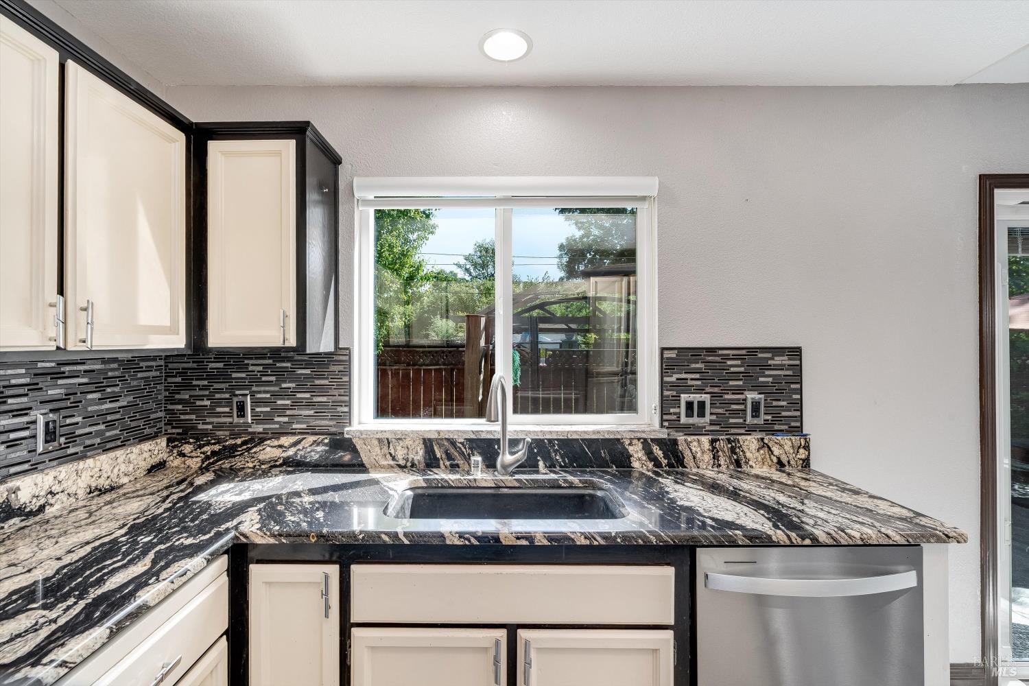 187 Wikiup Meadows Drive Santa Rosa, CA 95403 - Photo 23 of 66 a kitchen with granite countertop a sink and a window