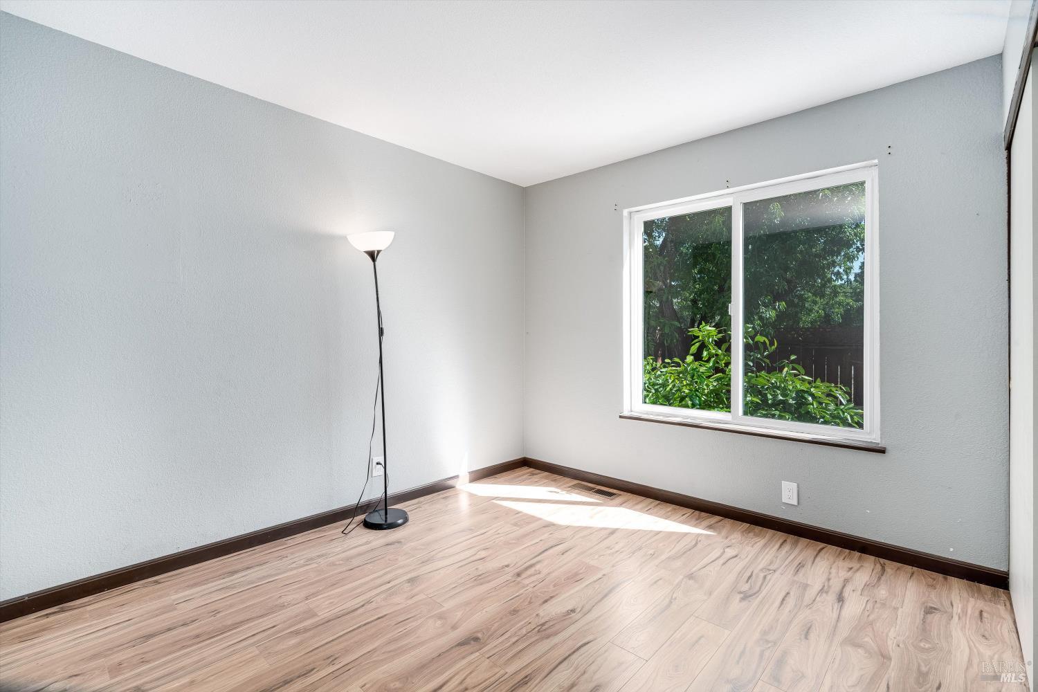 187 Wikiup Meadows Drive Santa Rosa, CA 95403 - Photo 25 of 66 an empty room with wooden floor and windows