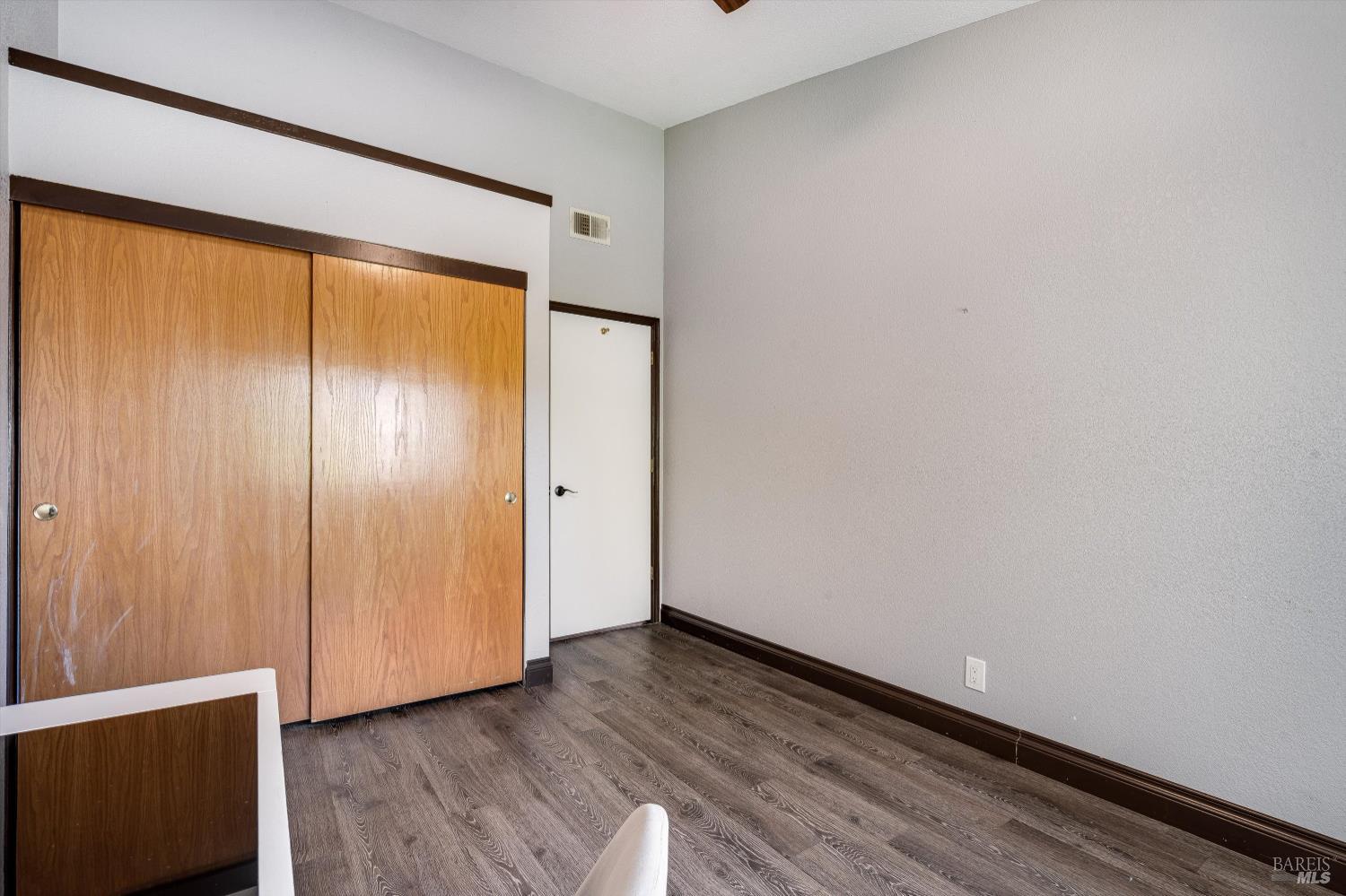 187 Wikiup Meadows Drive Santa Rosa, CA 95403 - Photo 34 of 66 a view of an empty room with wooden floor and a window