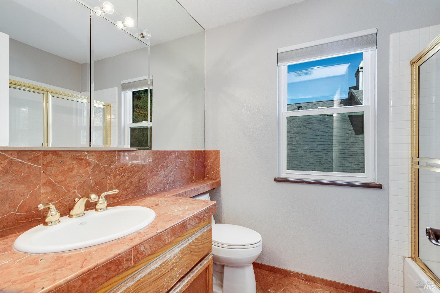 187 Wikiup Meadows Drive Santa Rosa, CA 95403 - Photo 35 of 66 a bathroom with a sink a toilet and mirror